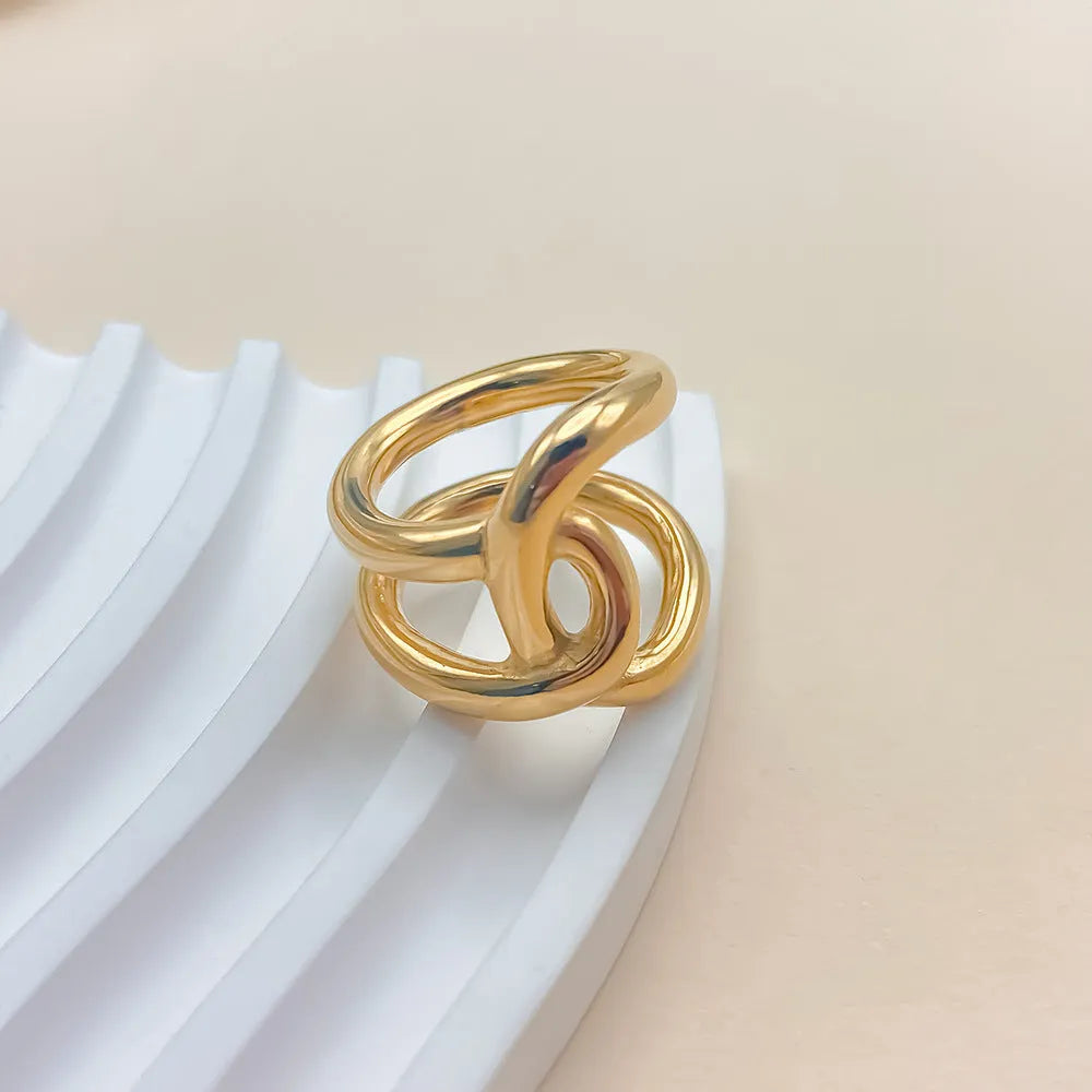 Adjustable stainless steel women's ring with geometric knot design on a U-shaped open band.