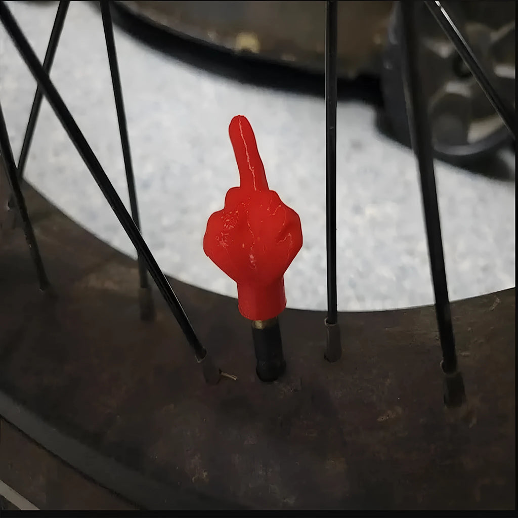 Four latex rubber tyre valve dust caps showing two black and two skin colour pieces