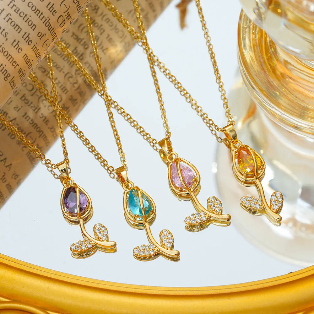Gold coloured titanium steel necklace with a detailed zircon tulip flower pendant on an O-ring chain.