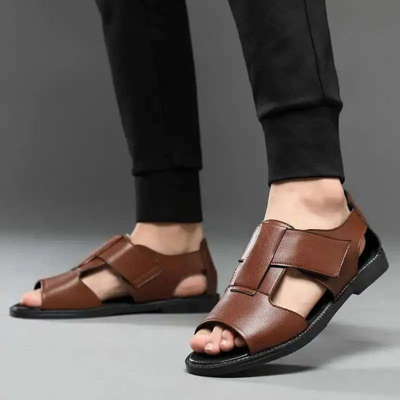 Men's black leather Roman sandals with open-toe design and rubber soles.