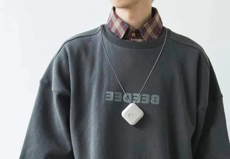 Mini USB air purifier necklace in pink, showing compact dimensions and wearable design.