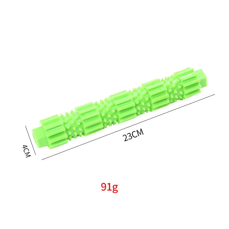 Green and orange durable rubber dog chew toy with textured surface and treat dispensing hole.