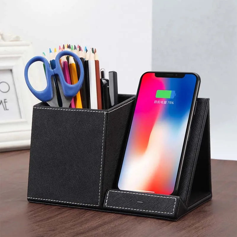 Black leather desk organiser with wireless phone charging pad and pen holder slots.