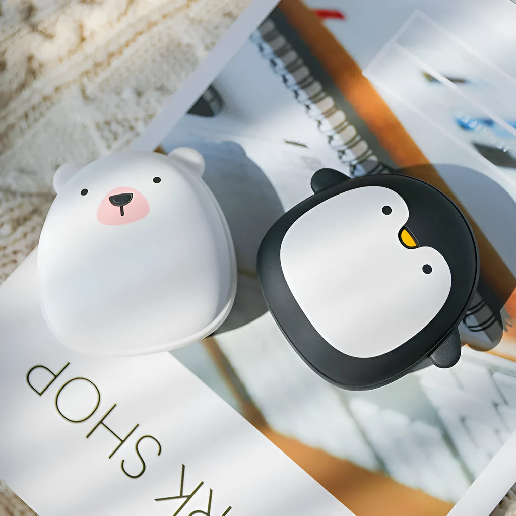 Cute cartoon penguin polar bear design USB rechargeable hand warmer and power bank unit.