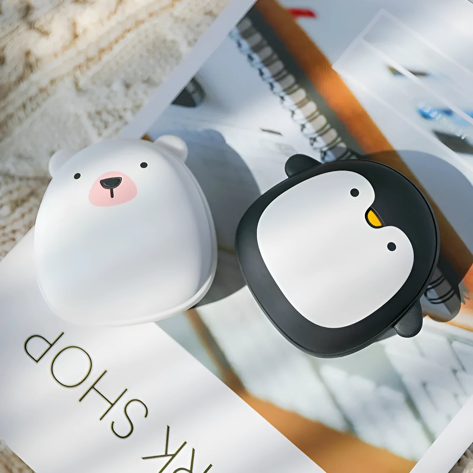 Cute cartoon penguin polar bear design USB rechargeable hand warmer and power bank unit.