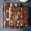 Brown solid acacia wood chopping board, 3cm thick, on a kitchen countertop.