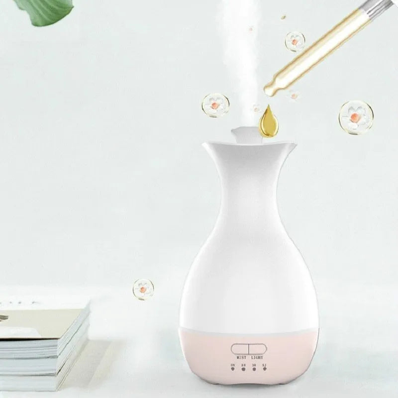 White or pink ceramic ultrasonic air humidifier and essential oil diffuser with colourful night light, 200ml capacity.