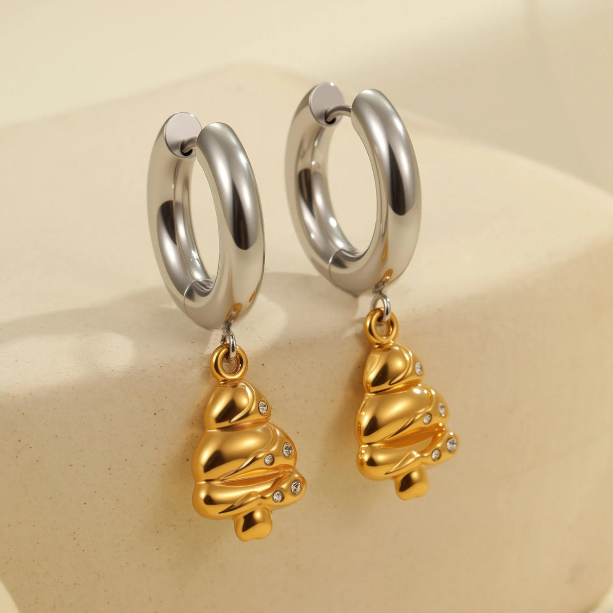 Christmas tree heart earrings in stainless steel with 18K gold plating showing heart and star shapes