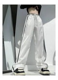 Low-waist loose straight-leg trousers with ribbon parallel bars detail in navy blue