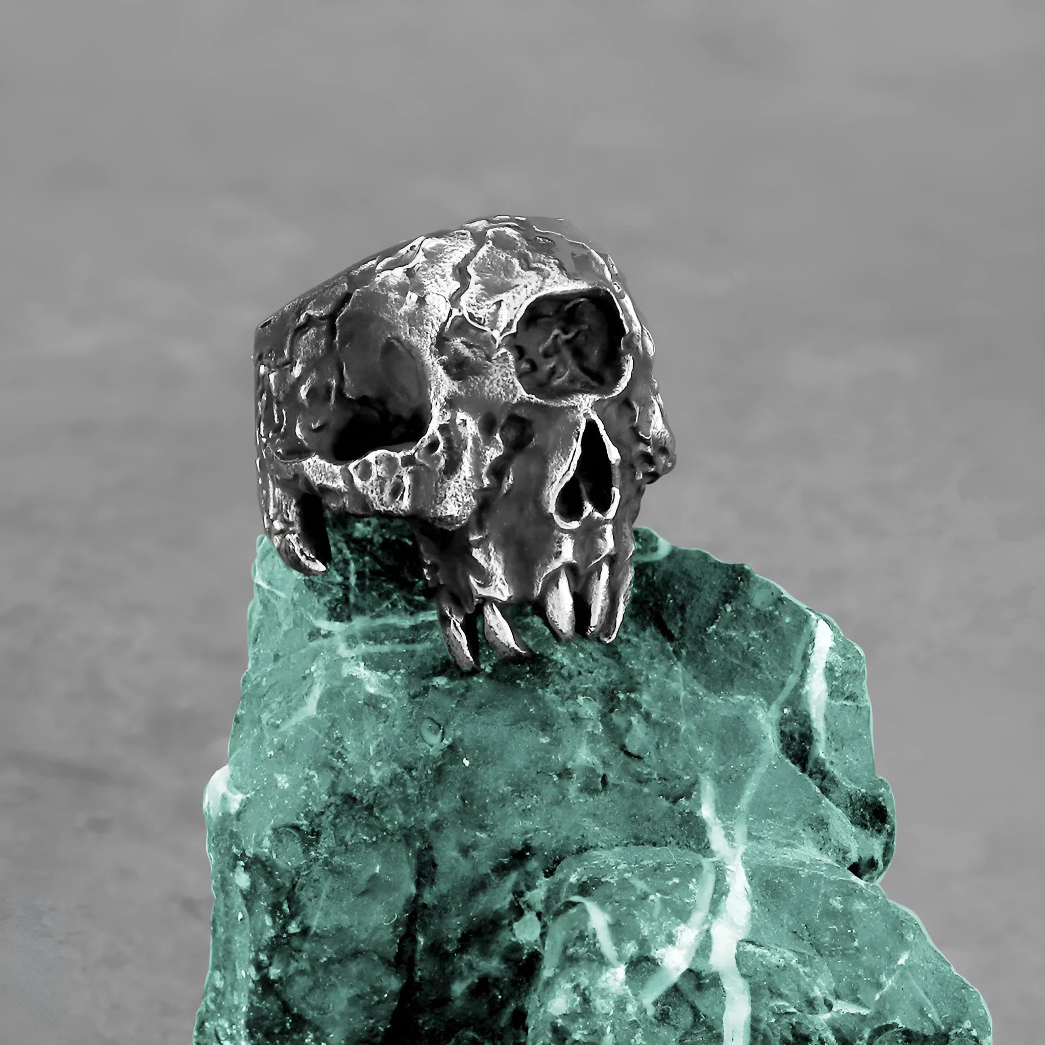 Silver alloy one-eyed skull ring with electroplated finish available in sizes 7 to 13