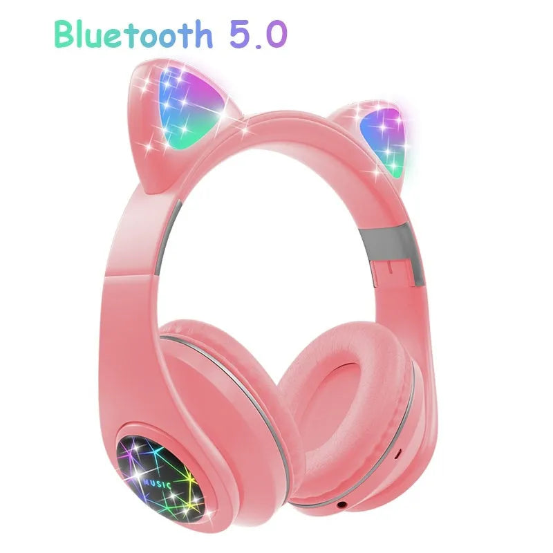 Colourful cat ear style wireless Bluetooth sports headset with a headband, shown in pink.