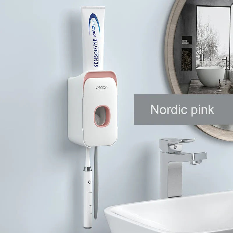 A blue automatic toothpaste dispenser mounted on a bathroom wall with a soft-touch button.
