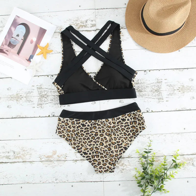 Leopard print women's bikini swimsuit with V-neck and cross banded design on a white background.
