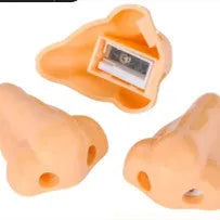 Flesh coloured geometry-shaped plastic manual pencil sharpener on a white background.