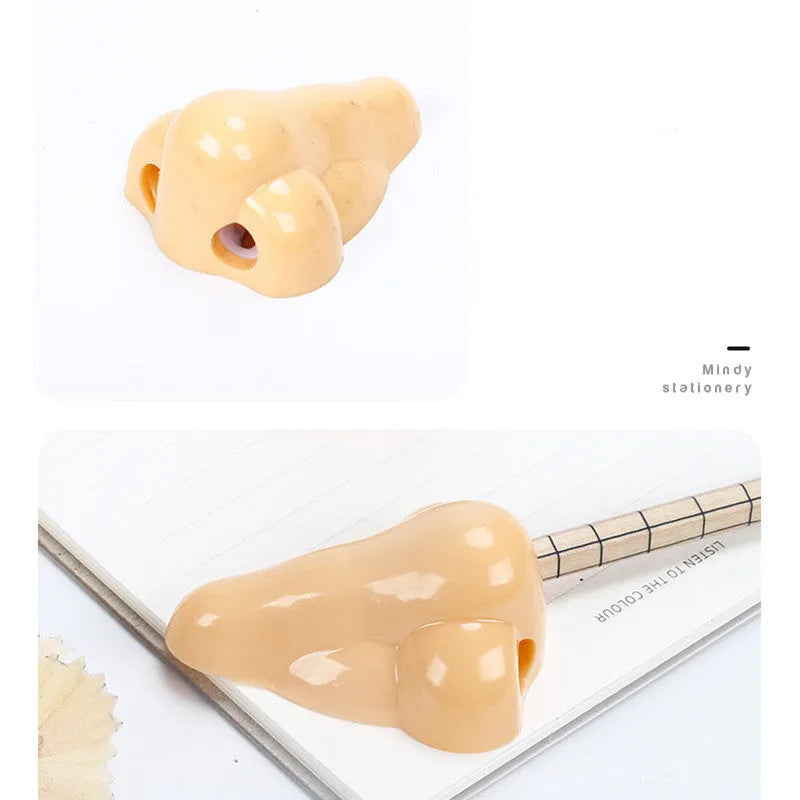 Flesh coloured geometry-shaped plastic manual pencil sharpener on a white background.