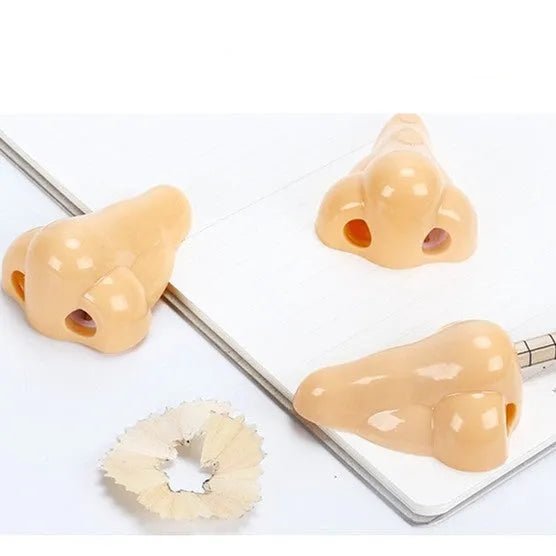 Flesh coloured geometry-shaped plastic manual pencil sharpener on a white background.