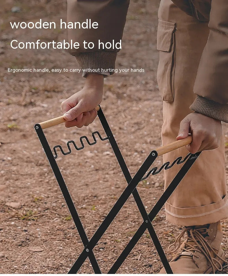 Black folding iron outdoor trash rack with a wooden handle holding a waste bag.