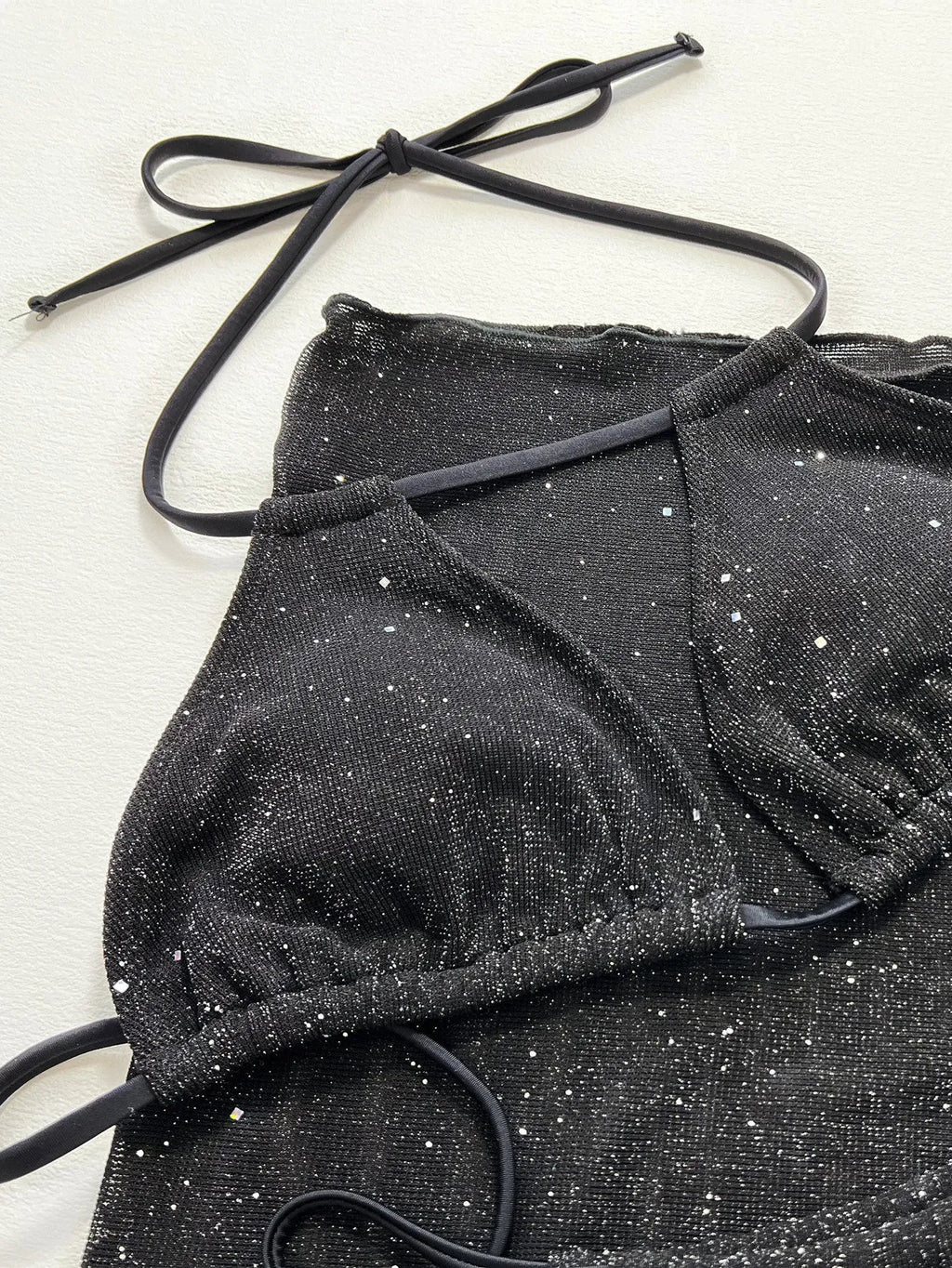 Black three piece bikini swimsuit set with separated top and shorts