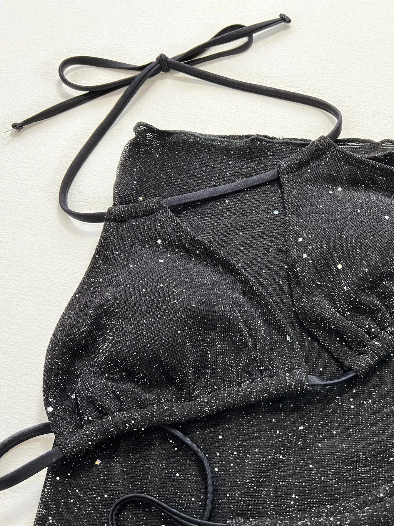 Black three piece bikini swimsuit set with separated top and shorts