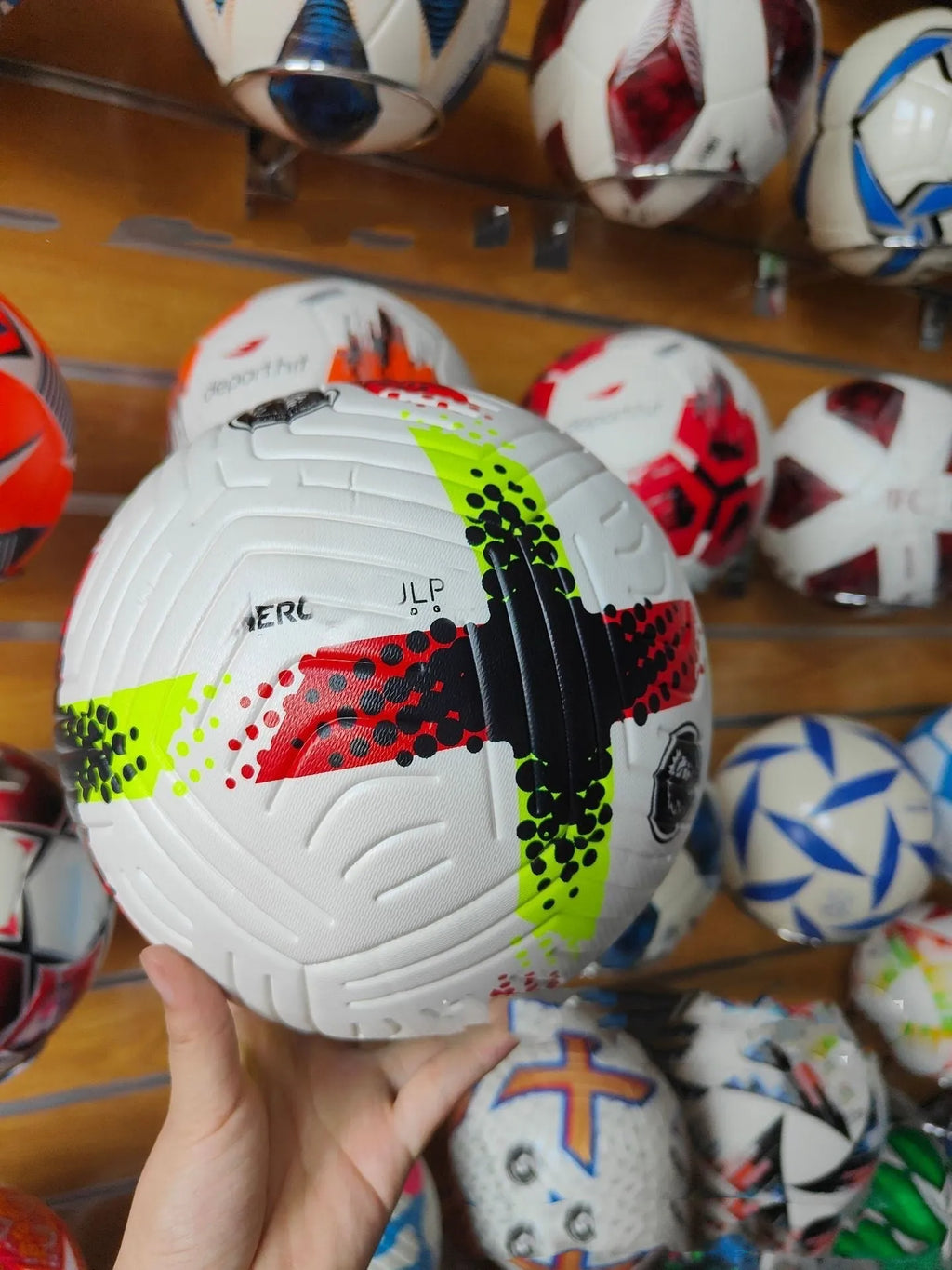 Fluorescent green Size 5 football with seamless thermal adhesive patch construction.