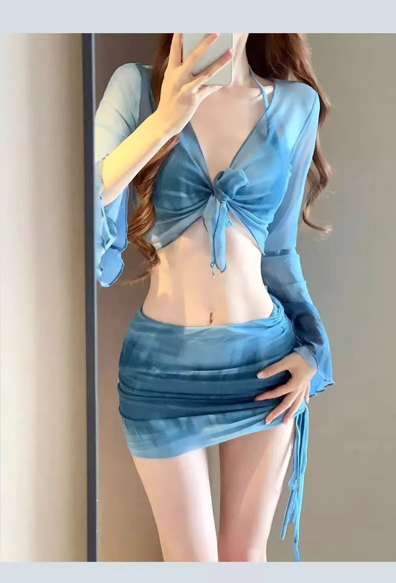 Blue four-piece women's bikini swimsuit set showing shirt, bra, underwear, and skirt with high-waisted design