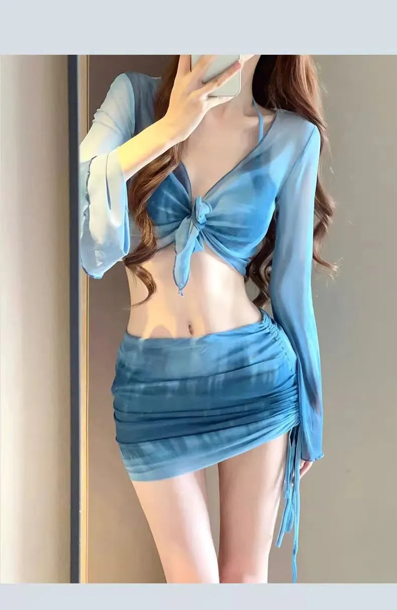 Blue four-piece women's bikini swimsuit set showing shirt, bra, underwear, and skirt with high-waisted design
