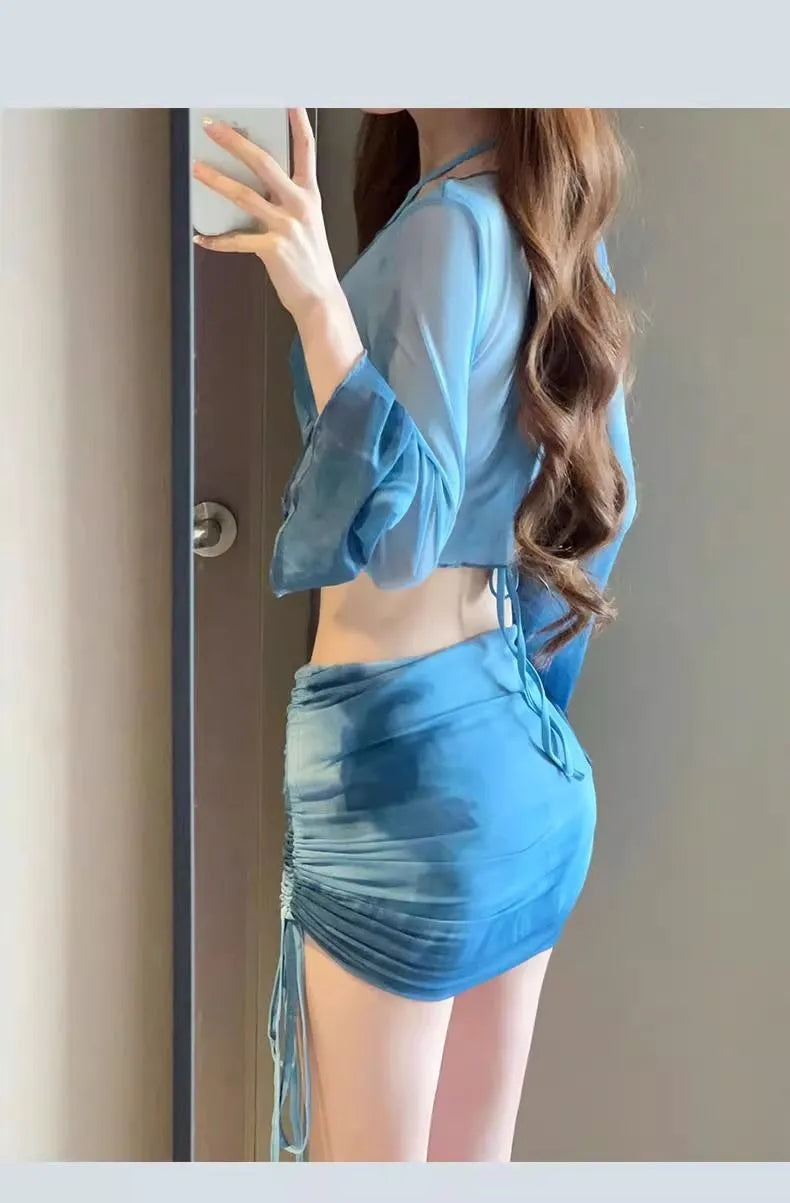 Blue four-piece women's bikini swimsuit set showing shirt, bra, underwear, and skirt with high-waisted design