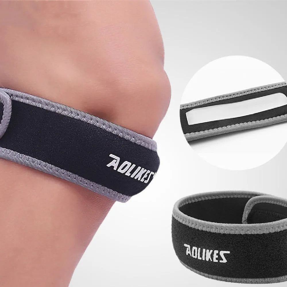 Black and grey patella retinaculum knee support for adult sports use.