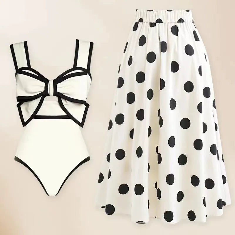 Women's black one-piece swimsuit with white bow and attached round skirt