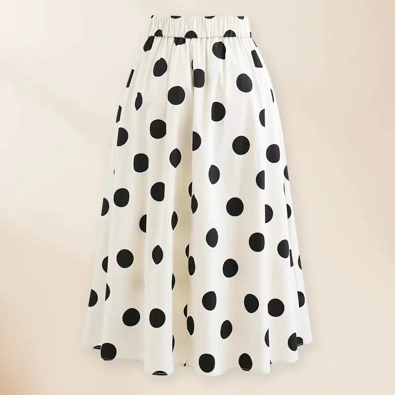 Women's black one-piece swimsuit with white bow and attached round skirt