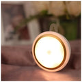 Smart battery-powered motion sensor LED night light with 80mm white casing on a wall