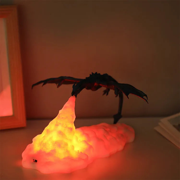 3D printed red dragon night light glowing on a table next to its USB charging cable.