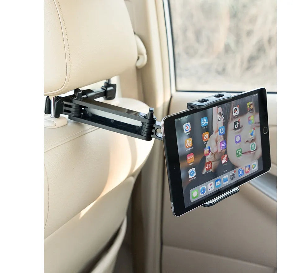 Black car phone holder attached to vehicle rear seat base with universal bracket holding tablet