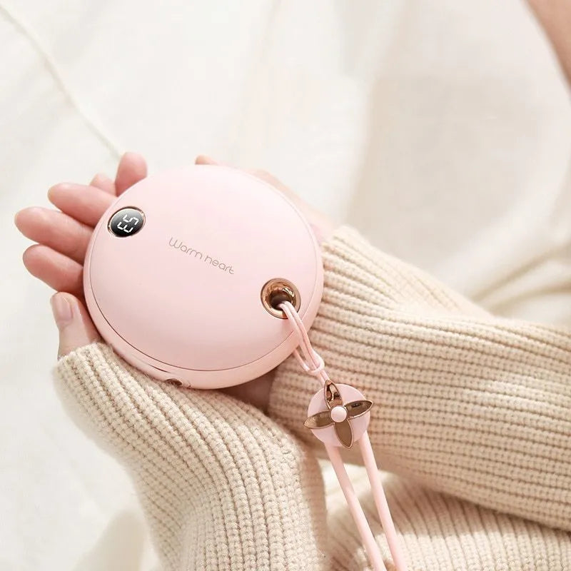 Green hand warmer power bank showing digital display with 5000mAh capacity