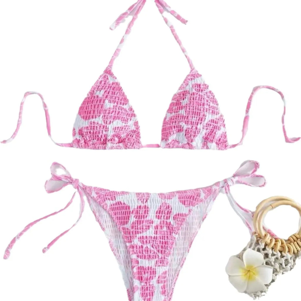 Women's floral pattern halter swimsuit briefs in light blue on a mannequin.