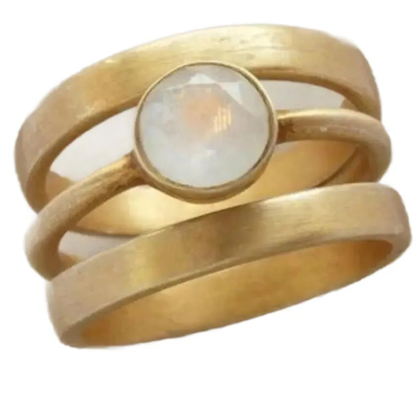 A gold-plated geometric ring with a micro-inlaid white chalcedony stone on a titanium steel band.
