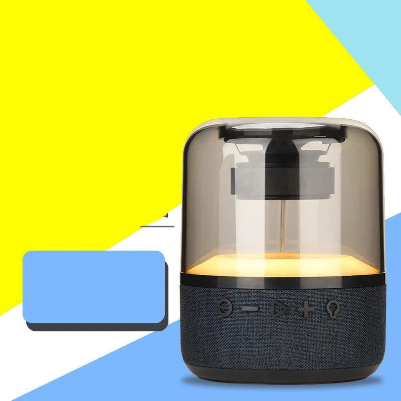 Black wireless Bluetooth speaker with multi-colour LED halo lights glowing around its base.