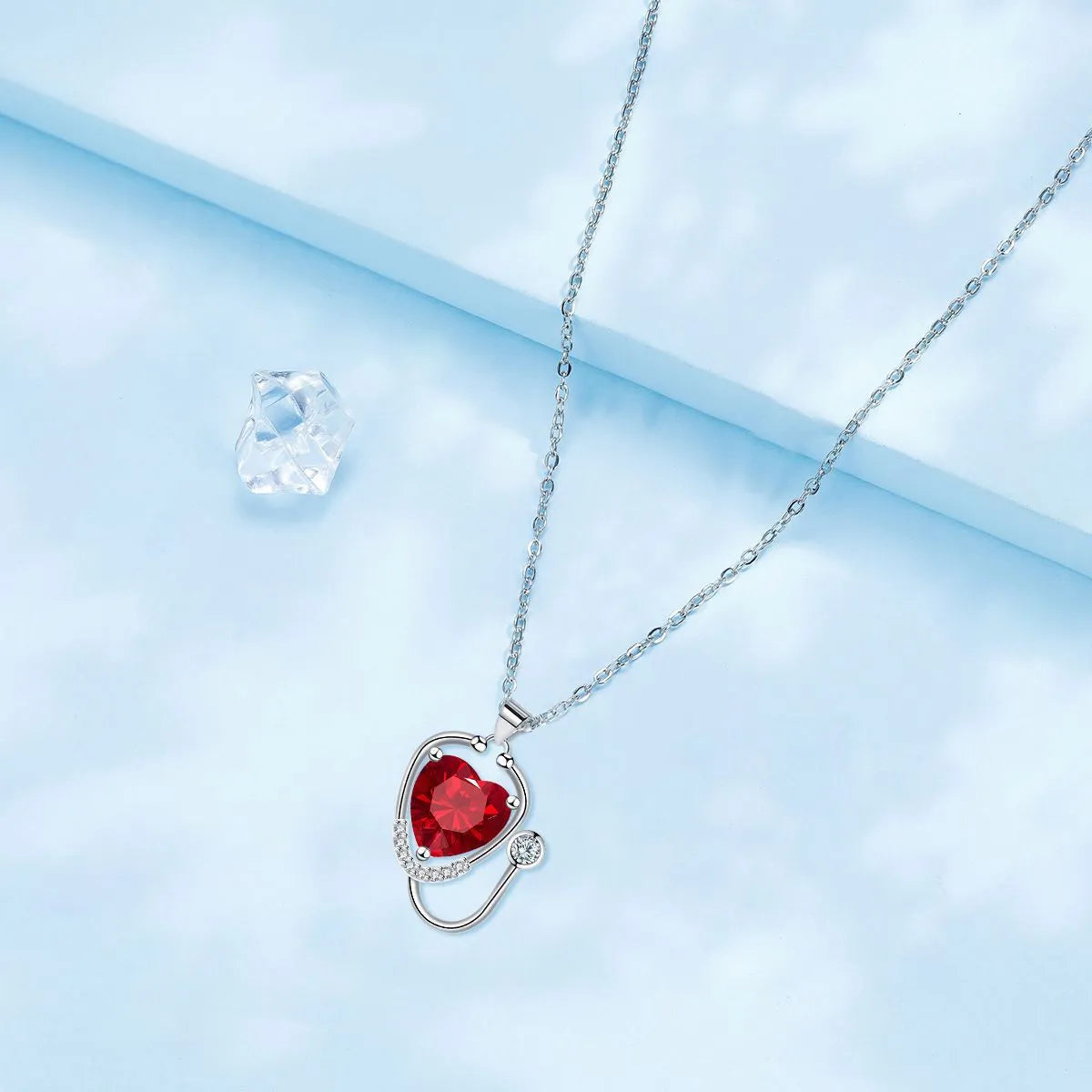 Women's copper electroplated stethoscope wings cross necklace in red diamond colour