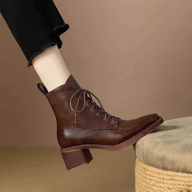 Women's black pointed toe short tube boots with 5.5cm heel on wooden floor