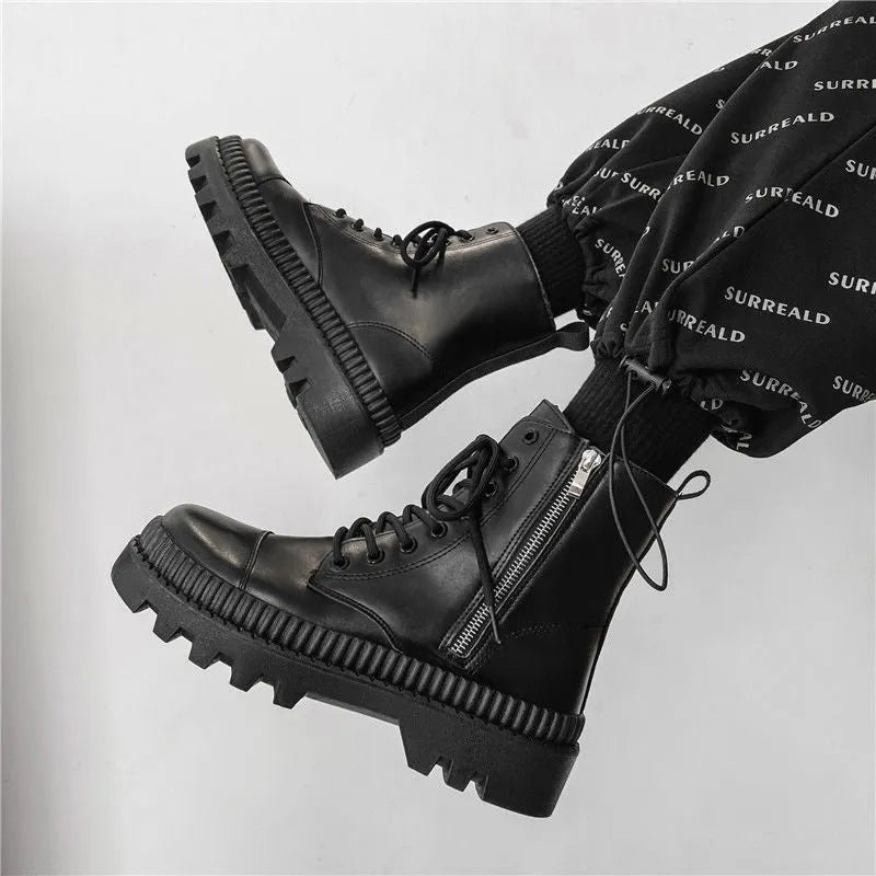 Men's black platform Dr. Martens ankle boots with side zipper and elastic fly weave panel.