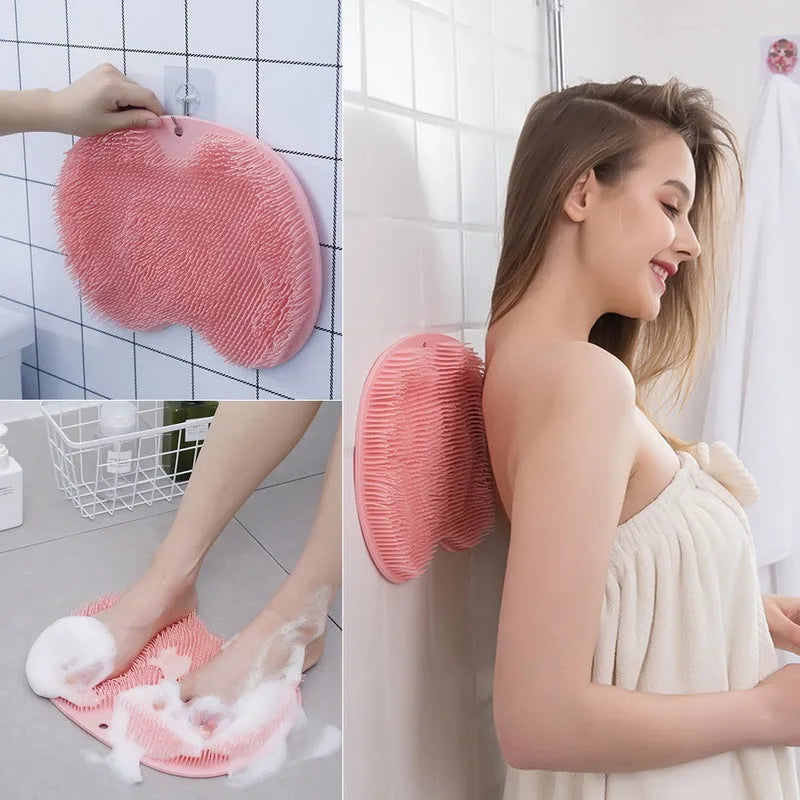 Orange silicone bristle massage bath brush with suction cup bottom on bathroom floor