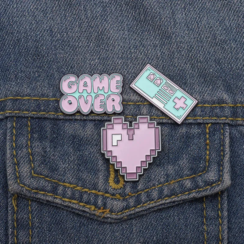 Stereo game console design metal badge with pin back, shown in one of three alloy colour options.