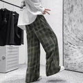 Man wearing black plaid retro loose-fit straight-leg casual trousers.