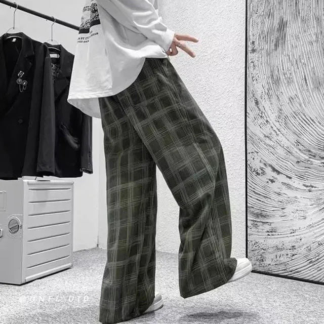 Man wearing black plaid retro loose-fit straight-leg casual trousers.