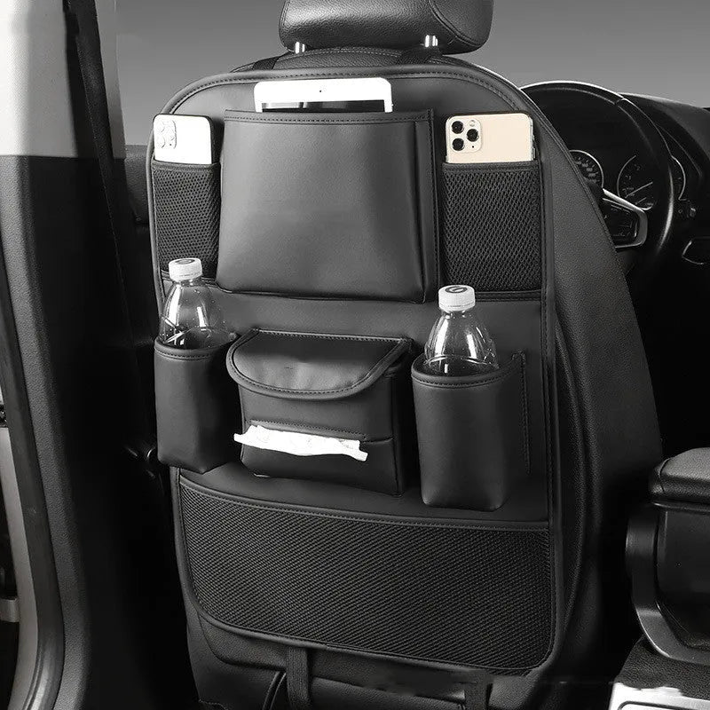 Synthetic leather car seat back storage bag hanging on the back of a grey car seat.