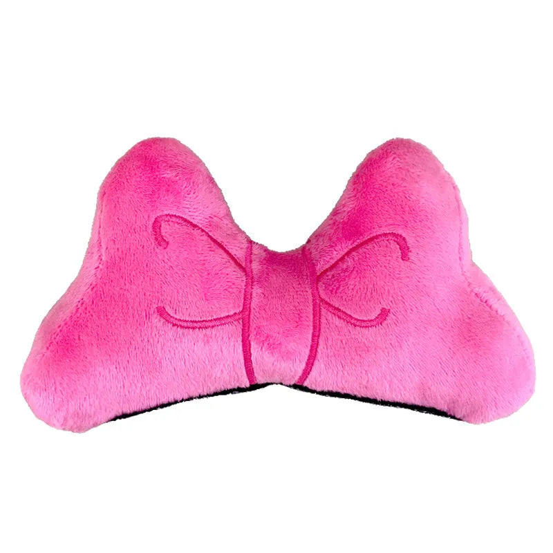 Soft plush decorative bow for motorcycle and ski helmets in red or pink.
