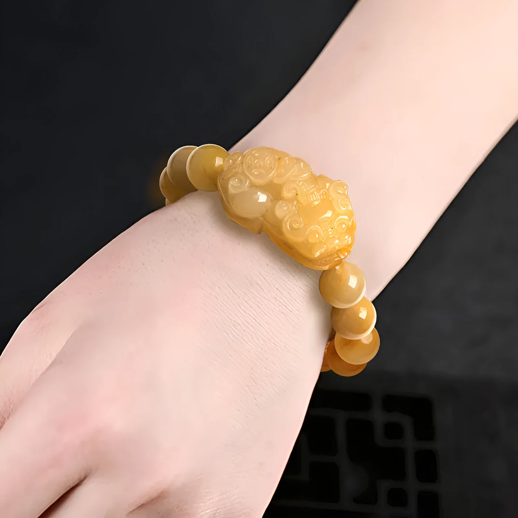 Hand-carved Jinsi Jade money bracelet showing golden thread colour, available in large or small sizes with different bead diameters.