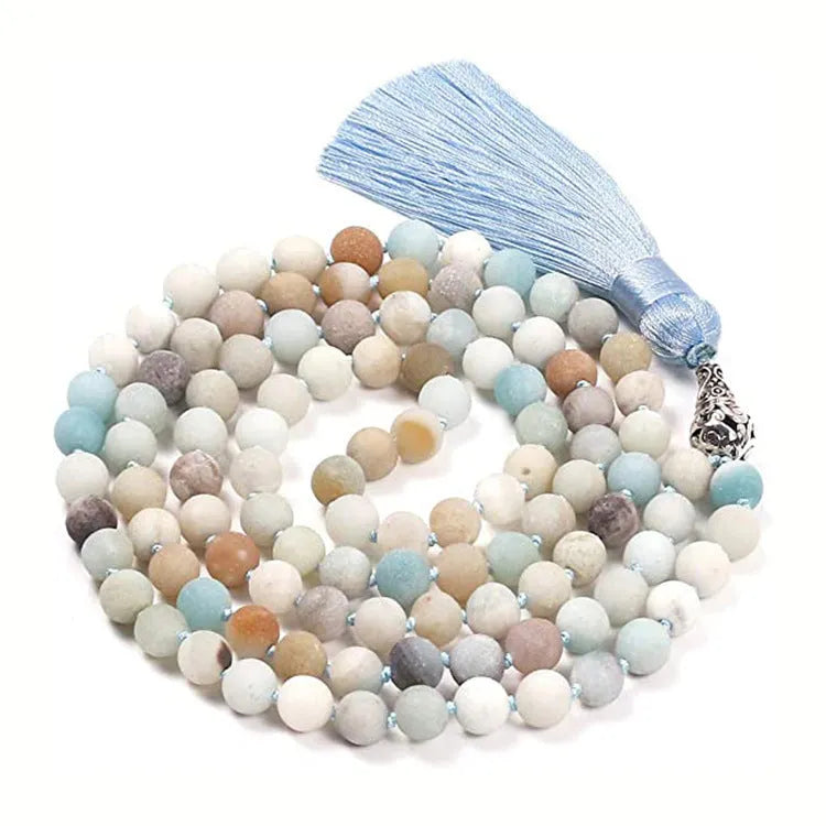 Long beaded agate necklace with geometric stones and a tassel, showing colourful variations.