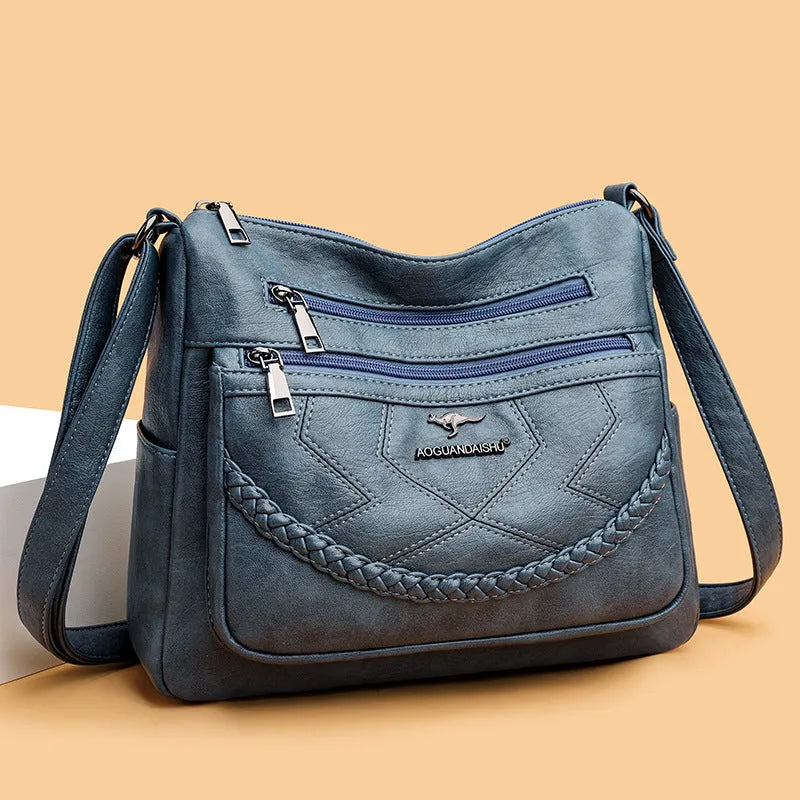 Soft PU leather crossbody shoulder bag in a horizontal square shape, shown in one of four colours: black, blue, red, or yellow.