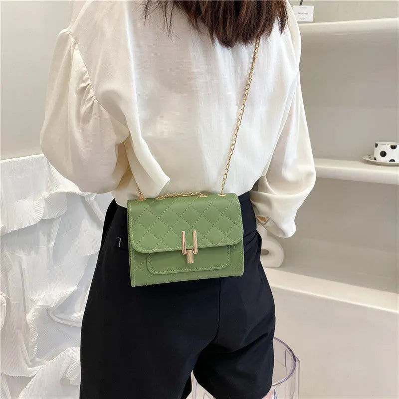 Women's white diamond lattice chain crossbody bag with adjustable shoulder strap showing dimensions